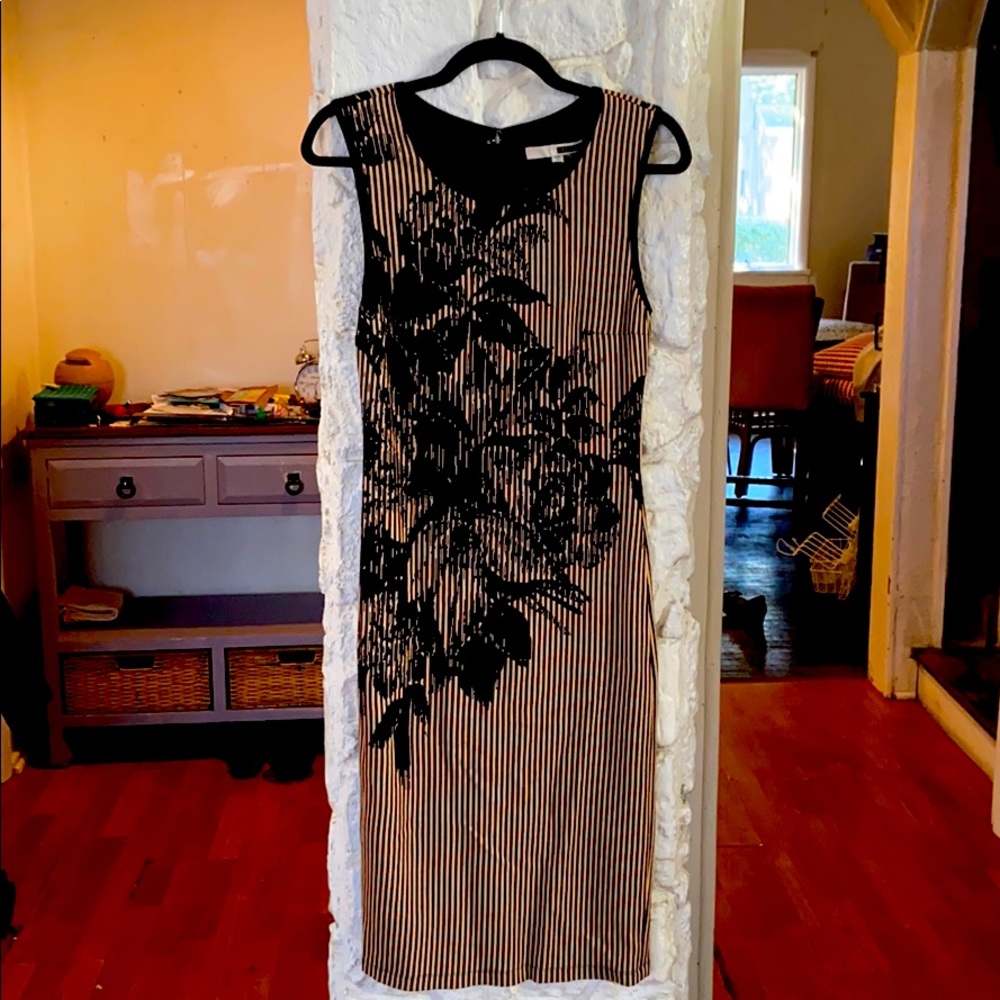Sleeveless dress, slightly below knee length.